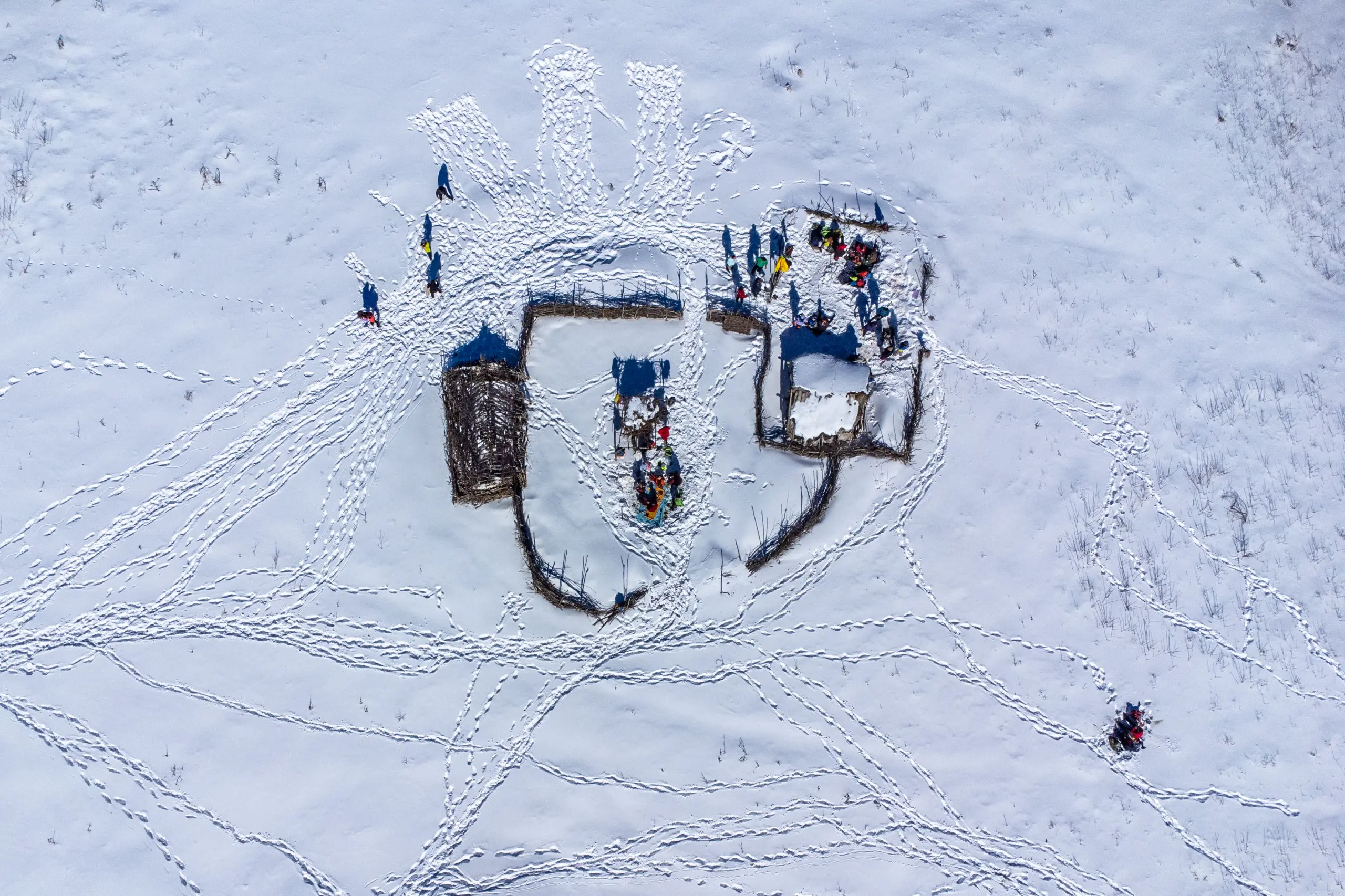 An aerial view of snow-covered structures and footprints on the Markouh Plain in Minoodasht, Golestan Province, during winter. Photograph by Mohammad Ataei.